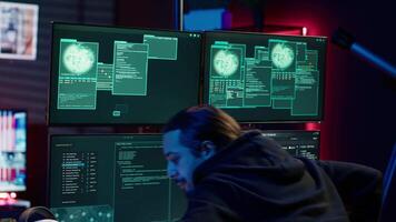 Cheerful cybercriminal celebrating after managing to get past security systems, hiding in secret HQ. Joyous hacker feeling proud after breaching defenses using rogue scripts, camera A video