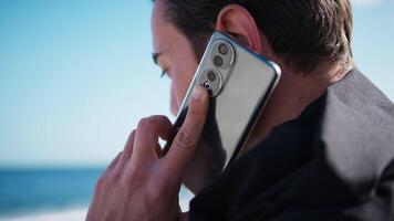 Boy Talks On The Phone At The Sea video