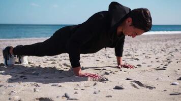Boy Does Push Up Exercises In Outdoor Gym On The Beach Near The Sea video