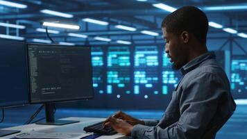 Software developer programming in high tech facility with server rows providing computing resources for different workloads. IT expert supervising data center supercomputers video