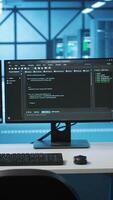 Vertical Computers in empty high tech data center establishment monitoring hardware energy consumption. PC monitors on desk used for checking potential system failures in server room video