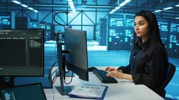 IT engineer in data center using PC to find misconfigurations affecting rackmounts performance. Woman checking servers bottlenecks leading to sluggish data transfer rates and malfunctions video