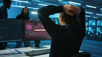 Admin in server hub panicked by valuable data threatened by hacking attack on computers. Scared coworkers failing to safeguarding data center against unauthorized access and vulnerabilities video