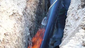 Welding plastic pipe. Workers with professional equipment for high-quality preparing for gluing pieces of plastic pipe in a single pipeline. Slow motion. Close up video