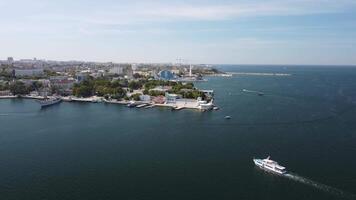 Sea bays of Sevastopol in Crimea during summertime in sunny weather. The aerial drone panoramic view an array of ships and boats, seaside tourism and travel destinations. video