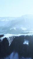 snowy mountains with deep ravine and rock cliffs video