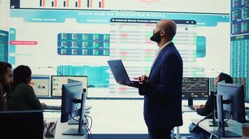 Business investor reviewing latest budgeting plans on a big screen with data reports, collecting details about financial updates to ensure global expansion. Shareholder making decisions. Camera B. video
