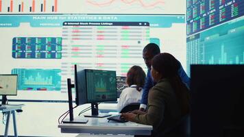 Financial analyst works on resource allocation plans with his staff, analyzing reports and sales infographics to find revenue. Achieve objectives in a competitive business environment. Camera B. video