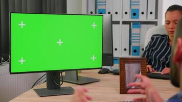 Handicapped businessman in wheelchair using computer with chroma key for videomeeting. Paralysed disabled freelancer looking at pc with green screen, mockup, key talking with remotely colleagues video