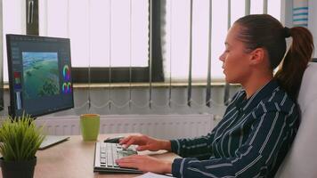 Freelancer hispanic videographer editing new project working in modern company creating content. Entrepreneur in professional workspace writing on computer keyboard looking at desktop video