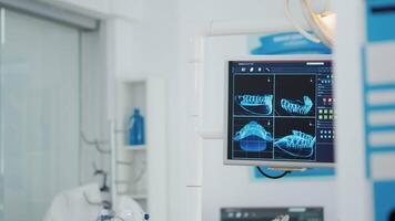 Close-up of teeth radiography on display in modern stomatology orthodontic hospital bright office. Empty orthodontist medical hospital office equipped with professional tooth instruments video