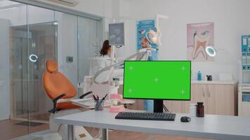 Dentist office with green screen on monitor and dental tools. Computer with isolated background and mockup template in cabinet for oral care and dentition. Medical space for dentistry video