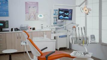 Closeup of revealing shot of stomatology orthodontist office equipped with dental drill and dentistry chiar ready for dental health treatment. Zoom in shoot of professional teeth instruments video