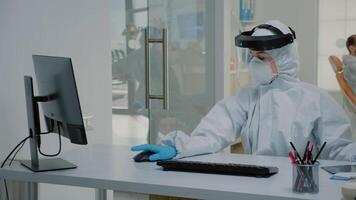 Stomatology assistant working at desk for patient teethcare using modern computer and oral radiography. Nurse and dentist doing dental consultation during coronavirus pandemic video