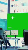 Vertical Diverse group of business specialists solve their daily tasks in control room with big greenscreen, analyzing big data numbers to ensure organizational progress. Startup management team. Camera B. video