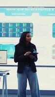 Vertical Enterprise manager looking into project updates and details in monitoring room, establishing resource allocation plans to achieve strategic business goals. Corporation operations. Camera B. video