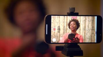 Vlogger is creating a beauty tutorial using makeup tools, filmed on a smartphone camera video