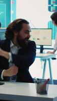 Vertical Happy CEO showing his satisfaction and celebrating business success, obtaining more funds to expand internationally. General manager dancing around and doing high five with his team. Camera A. video