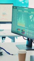 Vertical Empty telecommunications control room with workstations, coworking space equipped with a big screen and modern devices used in organizational daily tasks and projects. Camera A. video