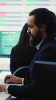 Vertical Sales manager reviews financial reports and performance metrics to assess the organizational expansion plans in boardroom. Business consultant examining online infographics. Camera A. video