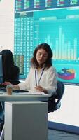 Vertical Business specialist reviewing key performance indicators within the firm activity. Conducting evaluations in order to help with global corporation expansion, enhance team efficiency. Camera A. video
