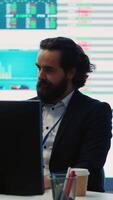 Vertical General manager working on data management with infographics and business activity reports, ensuring objective achievement. Shareholder reviewing an investment for global expansion. Camera A. video