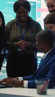 Vertical Diverse business employees group celebrate a successful outcome, obtaining more expansion funds and sharing a high five with all the staff members. Pleased workers enjoying success. Camera A. video
