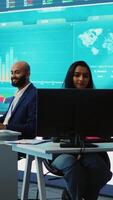 Vertical Forecast affiliates working in coworking space office to review latest business news based on performance metrics and progress. Consultants fight to expand the enterprise globally. Camera A. video