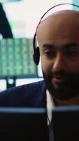 Vertical Management associate sharing insight on annual statistics during a call with the advisory board, providing initiatives to enhance operational performance metrics. Big data screen. Camera A. video