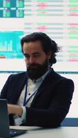 Vertical Project manager examining key performance metrics to ensure global business success, working with annual infographics to understand what needs improving. Multinational company activities. Camera A. video