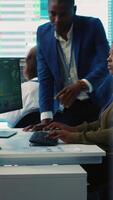 Vertical Business associates evaluating key performance indicators within the company, conducting evaluations and discussing workflow situation. Workers enhancing productivity and efficiency. Camera A. video