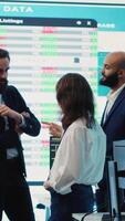 Vertical Staff members from a business enterprise discussing details and progress in a new project during a corporate meeting. Company experts getting informed about marketing developments. Camera A. video