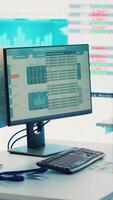 Vertical Multinational company headquarters office with a big data screen, technology used for employees to monitor numbers and infographics relevant to business development or expansion. Camera A. video