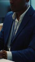 Vertical Chief executive officer reviewing project details about achieving business goals, establishing resource allocation. Administrator works in a firm monitoring room with big screen. Camera A. video