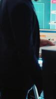 Vertical General director CEO sharing insight about a new development strategy with his employees, showing important data reports to analyze organizational activity status in a control room. Camera A. video
