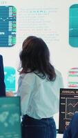 Vertical Forecast affiliates deciding new direction to improve business efficiency, reviewing latest enterprise news and progress. Worker and general director working to expand the company. Camera A. video