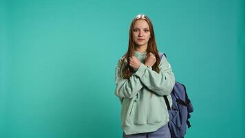 Assertive woman shows letter X with arms crossed, staying in warrior stance, showing fierceness. Firm young person using negative body language to signal rejection, studio background, camera B video