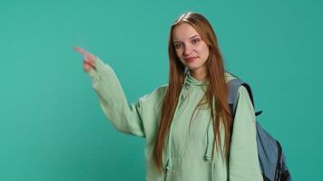 Portrait of cheerful person pointing finger towards empty space, doing advertising. Happy lady doing presentation, showing copy text, isolated over studio background, camera A video