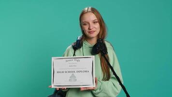 Overjoyed student celebrating achievement, holding diploma, using microphone to do speech, studio background. Woman using mic to share wisdom with colleagues after finishing school, camera A video