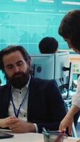 Vertical Staff member pitching an expansion idea directly to the business investor, presenting key performance indicators and annual success reports in order to obtain more funds. Camera A. video