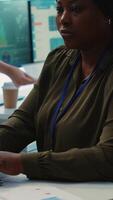 Vertical Enterprise manager analyzes annual reports and statistics on a pc, works on creating business strategies and goals. Analyst studying market dynamics and organizational progress. Camera A. video