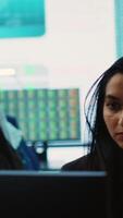 Vertical Company employees exchanging project details and big data to help in achieving business objectives, establishing budget and resources. Management team sharing information. Camera A. video