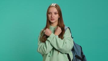 Assertive woman shows letter X with arms crossed, staying in warrior stance, showing fierceness. Firm young person using negative body language to signal rejection, studio background, camera A video