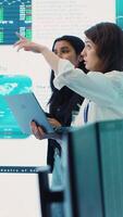 Vertical Coworkers team analyzing infographics to provide solutions on an issue affecting the project, looking to finish tasks before deadline. Business employees working together to ensure progress. Camera A. video