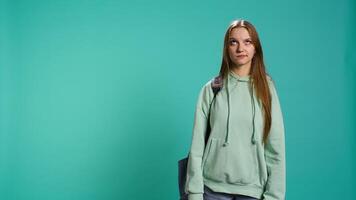 Young actress goofing around, switching emotions, trying different facial expressions, practicing for theatre class, studio background. Teenage woman making silly faces, camera B video