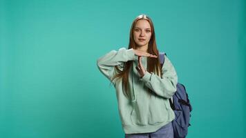 Portrait of assertive woman asking for timeout, doing hand gestures, feeling fatigued. Unhappy girl doing vehement pause sign gesturing, wishing for break, studio background, camera B video