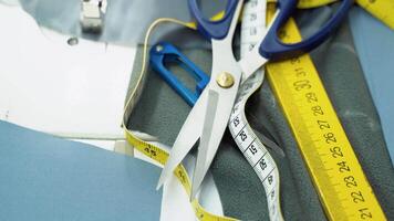 Threads, pattern, scissors, tape measure, and a sewing machine. Workplace of seamstress video
