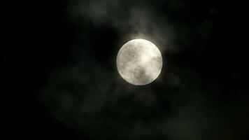The Full Moon shines brightly in the cloudy night sky, creating a mystical backdrop video