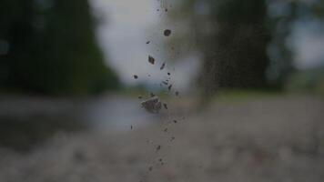 Capture a detailed closeup of the dynamic movement and arrangement of falling rocks video