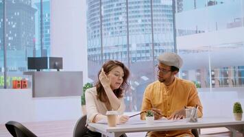 Client and realtor studying architectural plans for the property layout, evaluating investment opportunity at the end of an office tour. Studying blueprints during a meeting with salesman. Camera A. video